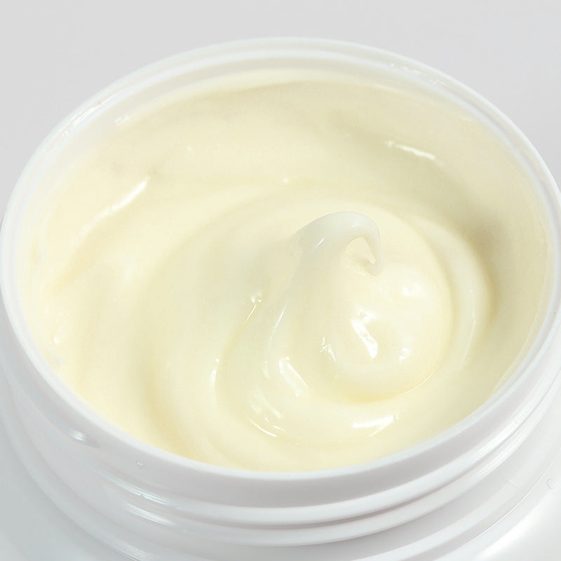Close-up of a white container with a creamy substance on a light gray background