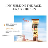 Sunscreen tube with packaging on a beach background, featuring SPF 50+