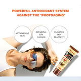 Woman applying sunscreen with text about an antioxidant system against photoaging, and a tube of sunscreen on a white background.