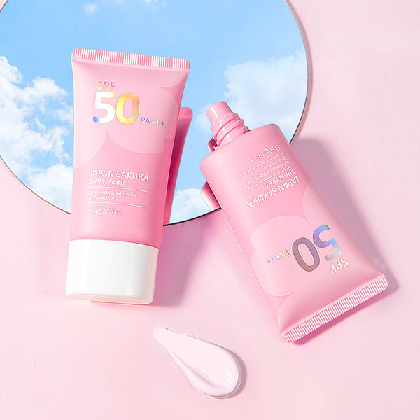 Two pink sunscreen bottles with SPF 50 on a pink background