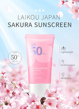 Pink sunscreen tube with cherry blossoms and 'Laikou Japan Sakura Sunscreen' text on a light blue background.