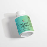 A bottle of 'Wonderful' brand Hair, Skin, and Nails Essentials capsules, with the label detailing the product's benefits and dietary supplement information.
