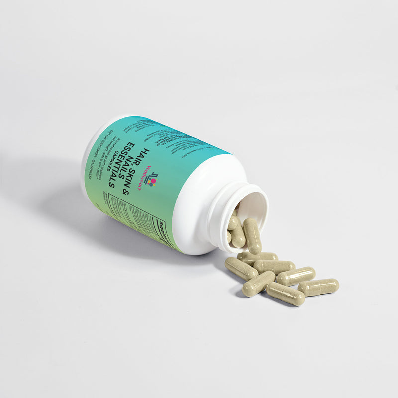 A bottle of 'Wonderful' brand Hair, Skin, and Nails Essentials capsules, with the label detailing the product's benefits and dietary supplement information.