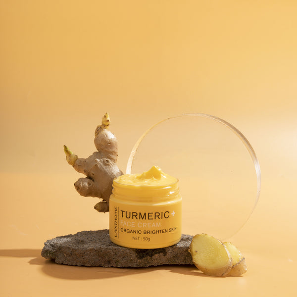 Jar of turmeric cream on a rock with a yellow background