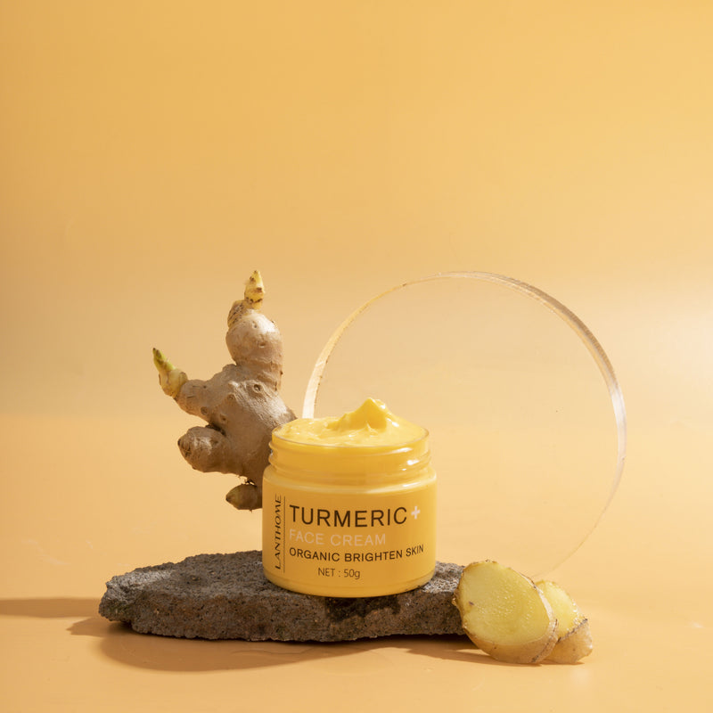 Jar of turmeric cream on a rock with a yellow background