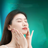 Woman touching her face against a teal background