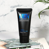 Black tube of Men's skincare product on a magazine with a marble background