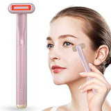 Woman using a pink facial roller on her face with a white background